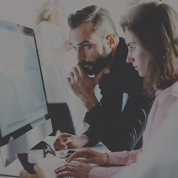 Coworkers working together on computer