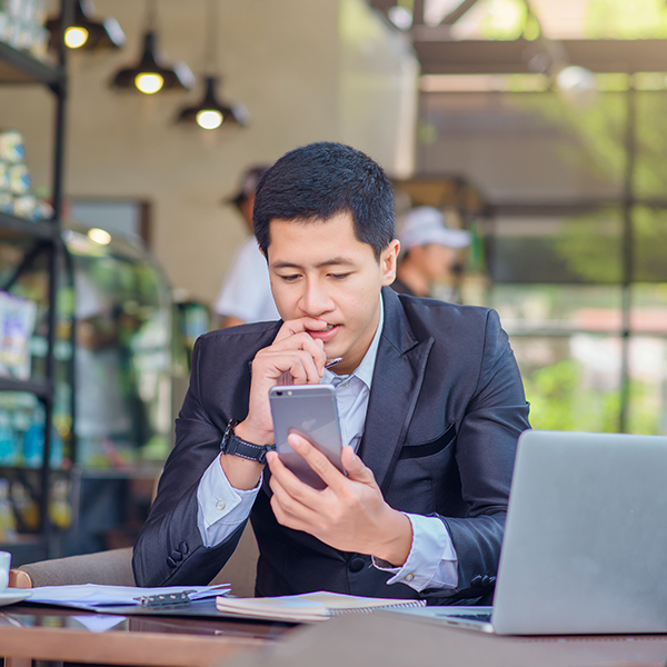 man checking email in cafe