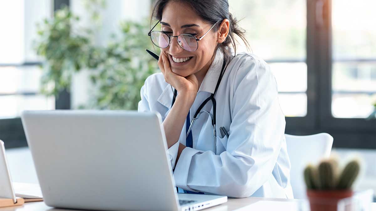 woman smiles at an email that was part of an agency's marketing to healthcare professionals campaign
